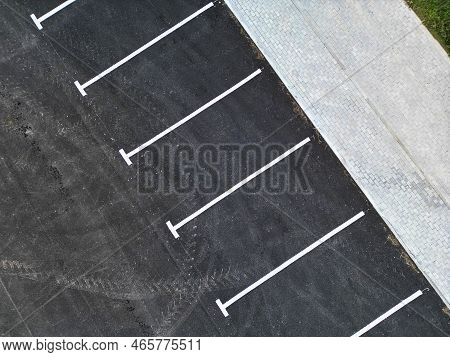 Top Aerial View Of Empty Spaces In Parking Lot. Parking Spaces For Cars. Parking On The Side Of The 