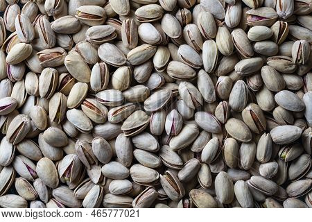 Pistachios Texture And Background. Pile Pistachio Kernels Nuts With Shell, Close Up. Pistachio Nuts.