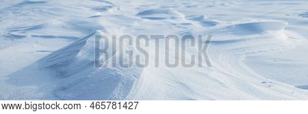 Snowy Background, Snow-covered Surface Of The Earth After A Blizzard In The Morning In The Sunlight 