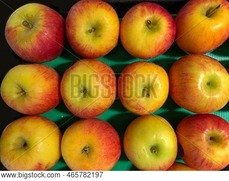 Cox Apples Arranged In Stack In Supermarket For Sale. Background Image Of Apple Fruits. Closeup View