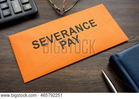 Envelope With Sign Severance Pay On The Desk.