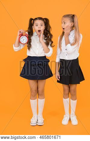 School Time. Schoolgirls And Alarm Clock. Children School Pupils. Knowledge Day. Surprised Shocked K