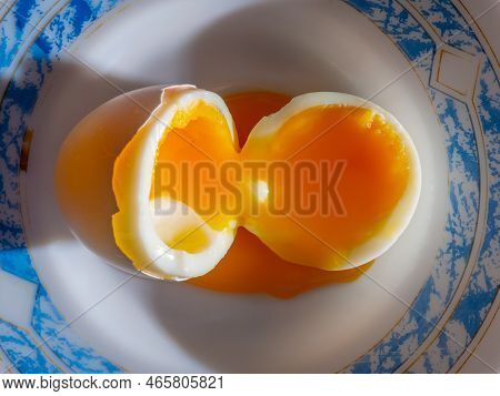 Top View Of A Soft-boiled Chicken Egg On A Plate. Selective Focus. Boiled Egg With Liquid Egg Yolk S
