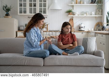 Shy Little Teenager Girl Turns Away From Smiling Mother Who Is Trying To Communicate. Cheerful Kind 