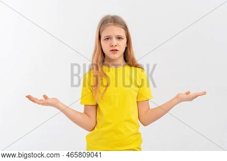 Confused Teen Girl Spread Palms Aside And Shrugging Shoulders, Saying Sorry, Dont Know, Have Nothing