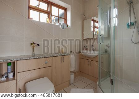 Foxton, Cambridgeshire - June 21 2018: Partially Tiled Simple Fitted Shower Room With Basin And Toil