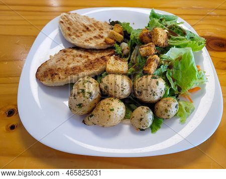 Plate With Grilled Chicken Breasts With Salad And Cambray Potatoes On A Wooden Table, Food
