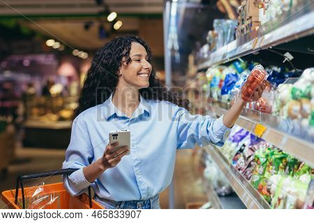 Woman Shopper Happy With Phone In Grocery Department Browsing Shopping List In Online App, Choosing 
