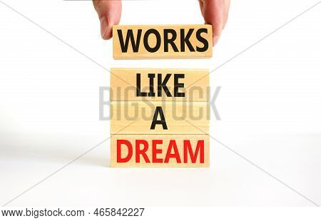 Works Like A Dream Symbol. Concept Words Works Like A Dream On Wooden Cubes. Beautiful White Table W