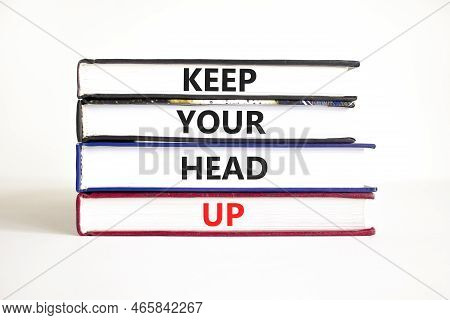 Keep Your Head Up Symbol. Concept Words Keep Your Head Up On Books. Beautiful White Table White Back
