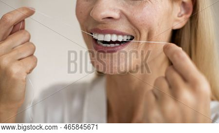 Toothcare And Oral Treatment Concept. Closeup Cropped View Of Unrecognizable Middle Aged Woman Using