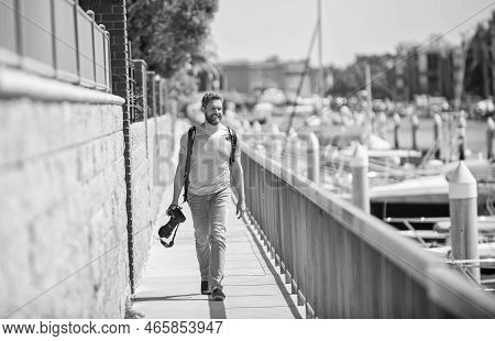Vacation Photographer. Travel Photographer Promenade Holding Camera. Summer Traveller Go Sightseeing