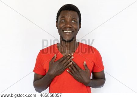 Portrait Of Happy African American Man Pressing Hands To Chest. Grateful Young Male Model With Short