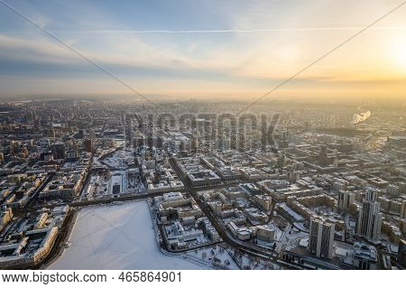 Embankment Of Central Pond And Plotinka In Yekaterinburg At Winter Sunset. Winter Snow-covered City.