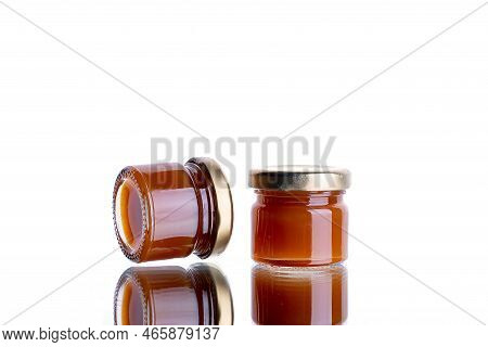 Jam In Many Jars On A White Isolated Background With Reflection. Orange Jelly Apricot Apple. Concept