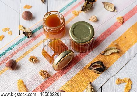 Cherry Jam In A Jar On A White Mirror Background With Splashes Of Water With Cherry Fruits And Their