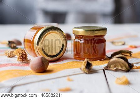 Cherry Jam In A Jar On A White Mirror Background With Cherry Fruits And Their Reflection. Concept Of