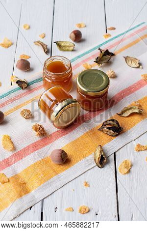 Cherry Jam In A Jar On A White Mirror Background With Cherry Fruits And Their Reflection. Concept Of