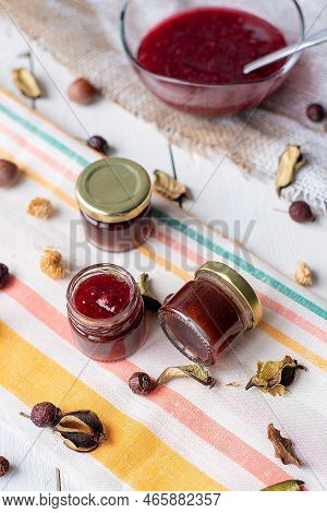 Jam In A Jar And A Spoon. Apple And Pear Jam In A Spoon On A White Mirror Background. Healthy Natura