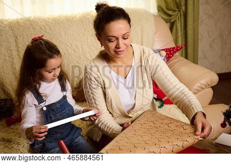 Affectionate Loving Mother And Her Lovely Daughter, Adorable Child Girl Using Wrapping Paper, Packin