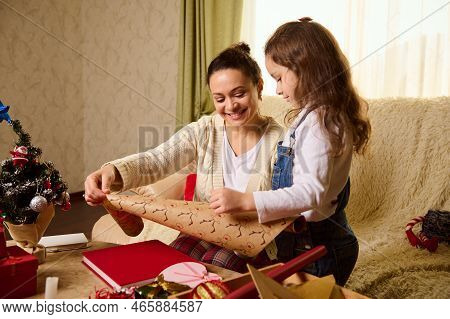 Pretty Woman, Loving Affectionate Mother And Little Girl Daughter Using Wrapping Paper For Packing C