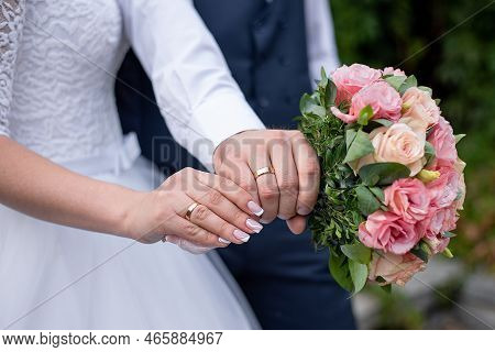 Bride\\\'s Hands On The Groom\\\'s Boutonniere. Wedding Decor For The Wedding Ceremony Of Flowers Fo