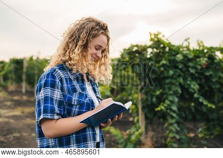 Young Woman Agronomist Investigate Plants And Diseases In The Vines. Idea Of Agriculture And Technol