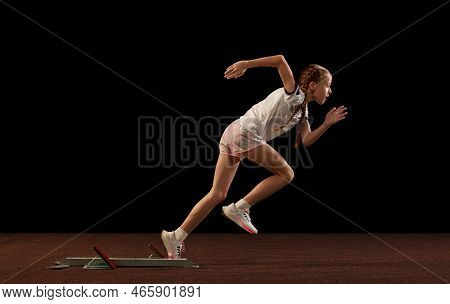 Focus On Movement. Portrait Of Begginer Athlete, Runner Training Isolated On Black Studio Background