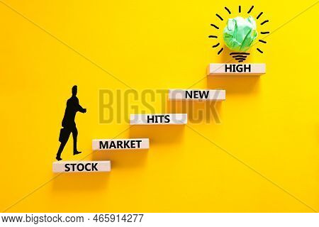 Stock Market Hits New High Symbol. Concept Words Stock Market Hits New High On Wooden Blocks On A Be