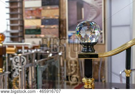Faceted Glass Ball With Multi-colored Highlights Is Mounted On A Wooden Staircase.