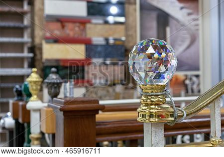 Faceted Glass Ball With Multi-colored Highlights Is Mounted On A Wooden Staircase.