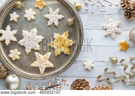 Stars And Snowflake Shortbread Cookies On A Vintage Tray With Decorations