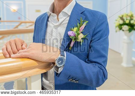Elegant Man In A Suit.boutonniere Of Eremurus, White Eustoma And Greenery Attached To Grooms Blue Ja