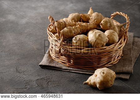 Jerusalem Artichoke Root, Sunchokes On Brown Table.