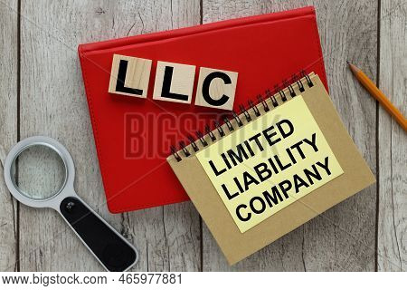 Limited Liability Company ,llc, Business Concept Background.text On Yellow Sticker And On Wooden Blo