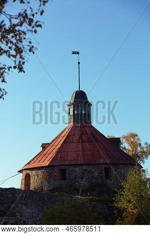 Korela Fortress In Priozersk, Russia. Stone Tower On The Background Of Blue Sky. Autumn Landscape Wi