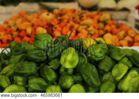 Heap Of Fresh Cascabel Chili Peppers On Counter At Market, Closeup