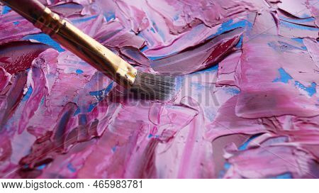 Brush On Artist's Palette With Mixed Paints, Closeup