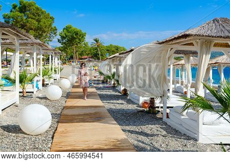 Camyuva, Turkey - September 23, 2022: Unidentified Woman Walks Along Beach Of Five-star Hotel Robins