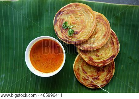 Paratha Bread Or Canai Bread Or Roti Maryam, Favorite Breakfast Dish. Served On Banana Leave