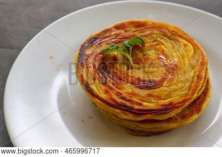 Paratha Bread Or Canai Bread Or Roti Maryam, Favorite Breakfast Dish. Served On Plate