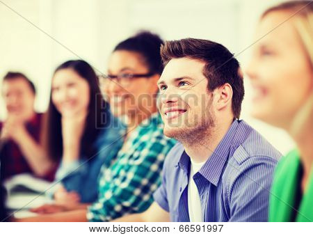 education concept - students with computers studying at school