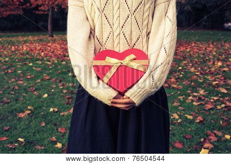 Woman With Heart Shaped Box In Park