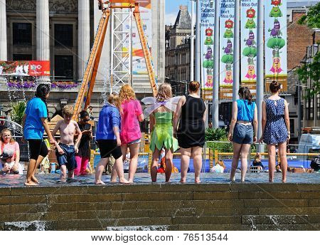 Teenagers at edge of fountain, Nottingham.