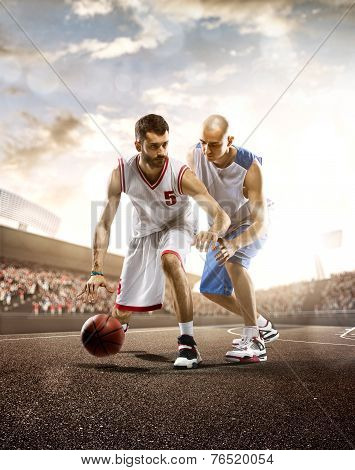 Basketball players in action on background of sky