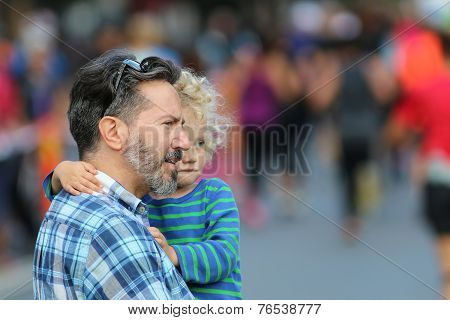 Father And Child Watching The Event