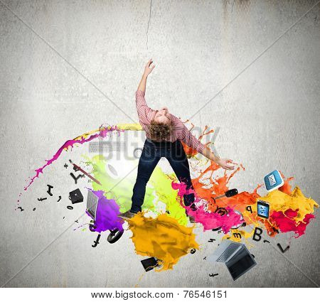 Young guy in casual evading from colorful splashes