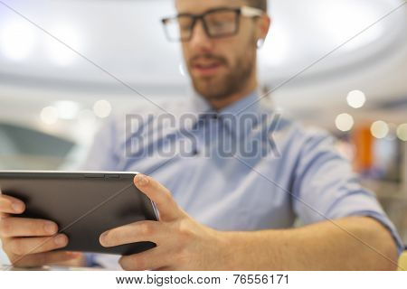 Young Businessman Seating On Table In Restoran And Use Mobile Device