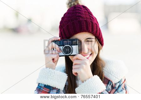 Teenage girl using vintage camera