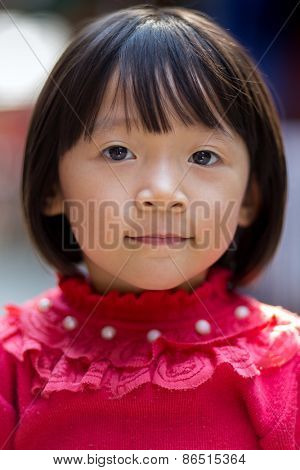 MAI CHAU, VIETNAM, DECEMBER 20, 2014: Portrait of a Vietnamese little girl in the street of the Thai ethnic village of Mai Chau, Vietnam